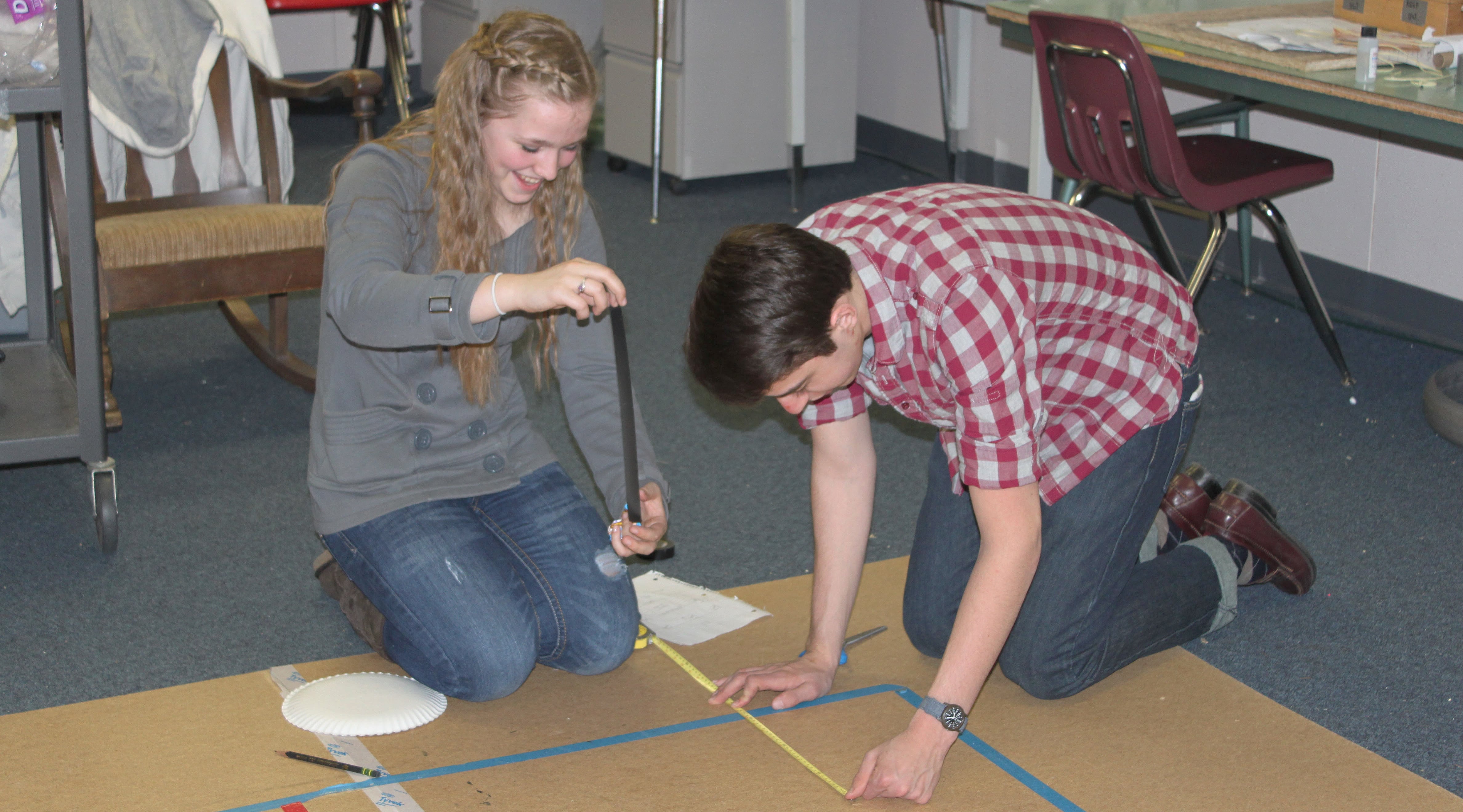 CHS Science Olympiad team members, including sophomore Katelynne Jones (left) and senior Ryan Gompertz (right) gathered Monday night to practice for the upcoming national tournament on May 20 and 21 in Wisconsin. Five days a week the team works out of its "clubhouse," one of the portables at Lacamas Heights Elementary School. Coach Ron Wright has called the facility one of the keys to the team's success.