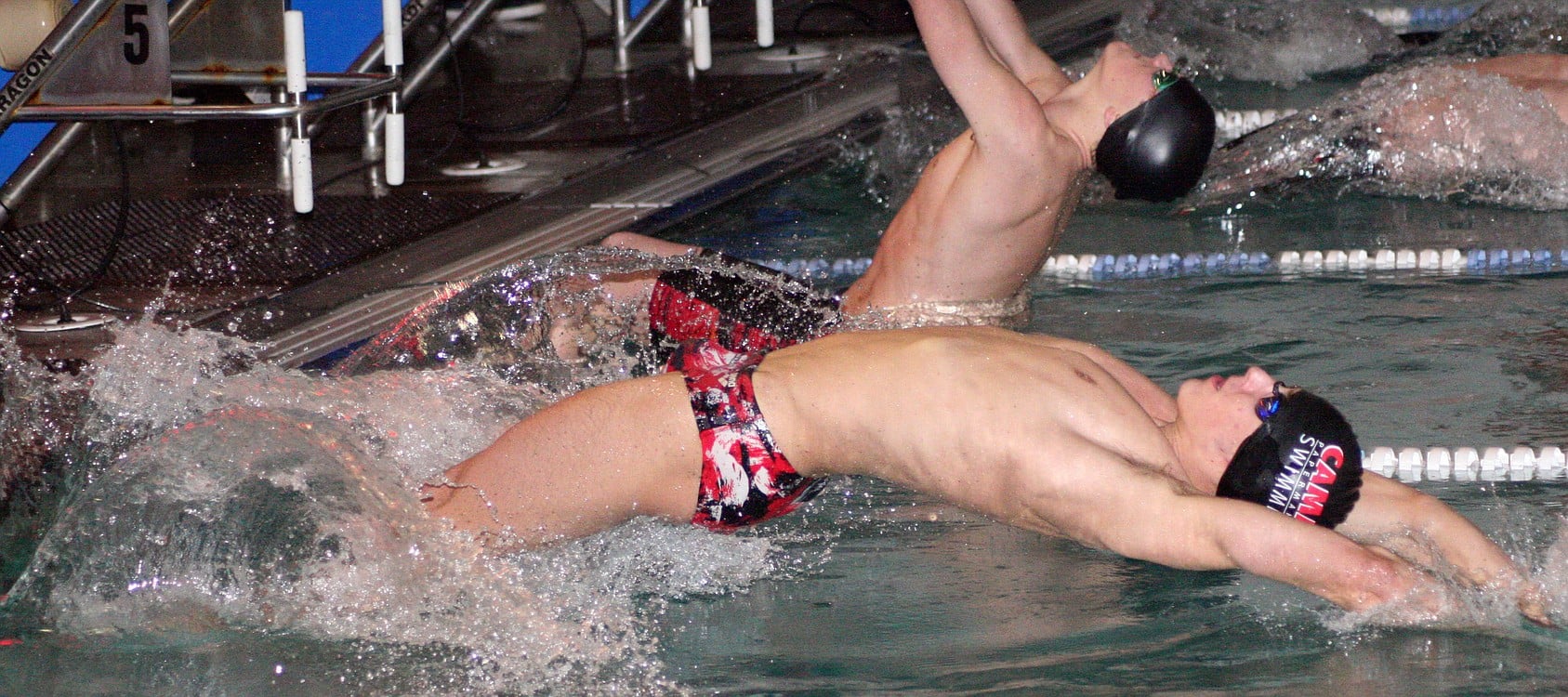 Lucas Ulmer launches into the 100-meter backstroke Wednesday, at LaCamas Swim & Sport. The Camas High School junior finished in first place in this event, the 100 butterfly and as a member of the 200 medley and the 400 freestyle relay teams.