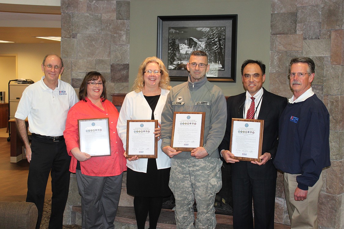 Eagle Rehabilitation at Camas recently made a pledge to support and honor the men and women who are members of the United States military Guard and Reserve.  Representatives from the Employer Support of the Guard and Reserve, a Department of Defense organization, recently visited the local facility to present certificates memorializing this commitment to U.S. troops. The ESGR was established to promote cooperation and understanding between Reserve members and their civilian employers and to assist in the resolution of conflicts arising from an employee's military commitment.  Pictured above are (left to right)  Camas resident Art McCallum, ESGR ombudsman; Sheri Boles, occupational therapist at Eagle Rehabilitation; Diane Backstrom, Eagle Rehabilitation director of nursing; Col. Daniel R. Kern, Washington National Guard; Paul McVay, Eagle Rehabilitation administrator; and Joel F. Scott, ESGR area chair for the Washington Committee. For more information, visit www.esgr.org.