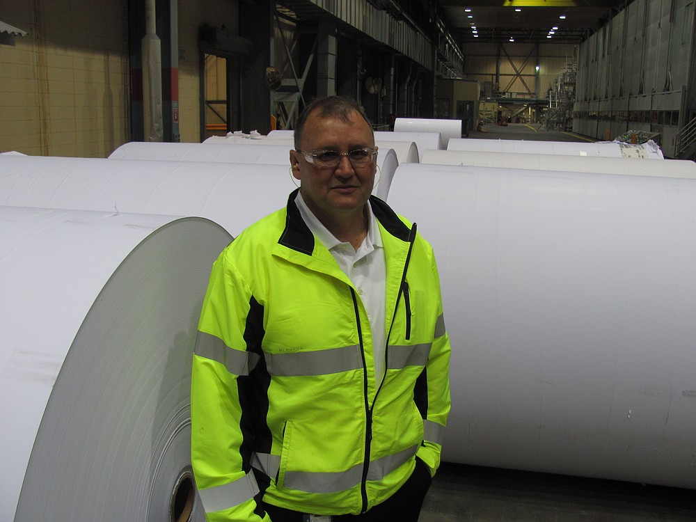 Joe Ertolacci, the new manager of the Georgia-Pacific mill, in Camas, stands next to communication paper rolls in the number 20 building. He has worked in the paper industry for 24 years.
