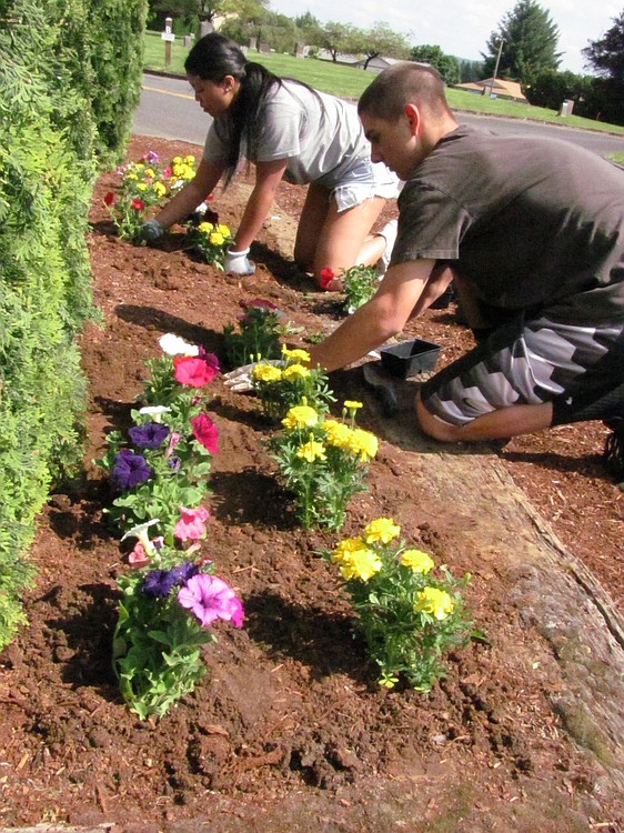 Nikayla Banks, vice president of the Washougal High School Interact Club, and member Nick Costa-Stange, planted marigolds and pansies Friday afternoon at the Washougal Memorial Cemetery. Several Interact members were involved in the volunteer planting effort, to prepare the site for Memorial Day weekend.