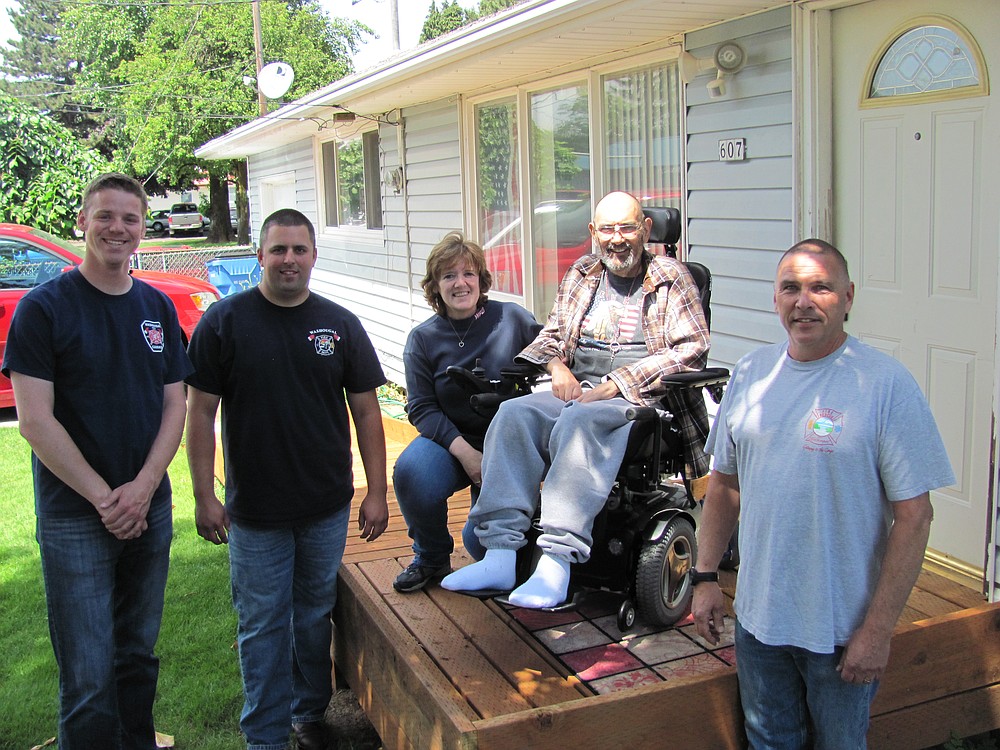 Several local fire officials recently coordinated the donation and installation of a ramp for Bob Dawson (second from right), who was diagnosed with ALS in 2013. Recently appearing with him were Jordan Boldt, Jake Grindy, Dawson's wife Charlie, and Joe Scheer. Charlie has served as a Washougal volunteer firefighter for more than 23 years. "They shocked us," Charlie said, regarding the addition of a ramp. "It was really nice."