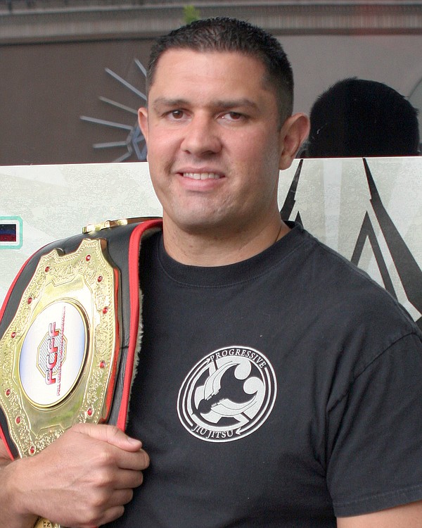 Chris de la Rocha of Washougal poses with his Full-Contact Fighting Federation Heavyweight title belt.