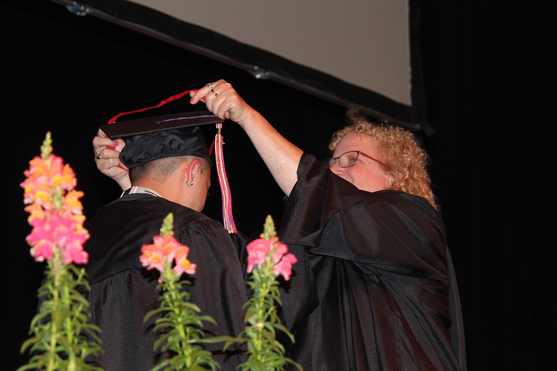 Excelsior Principal Carol Boyden presents Jorge Alberto Trujillo-Pineda with the first $500 Cheryl Trent Memorial Scholarship. Trent, a former teacher, died in November 2013 after a long battle with cancer. Boyden said the scholarship is presented to a student "who has struggled, who has worked hard and who has accomplished the goal of graduation and has never given up."