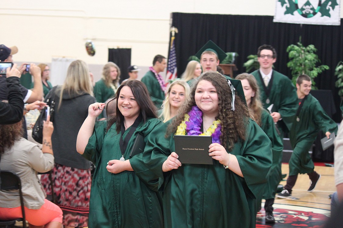 Hayes Freedom High School graduates BreAnna Taylor (left) and Lindy Treece (right) are all smiles as they carry their diplomas at the close of ceremonies. They were among the 34 young people  who are part of the Renegade Class of 2014.