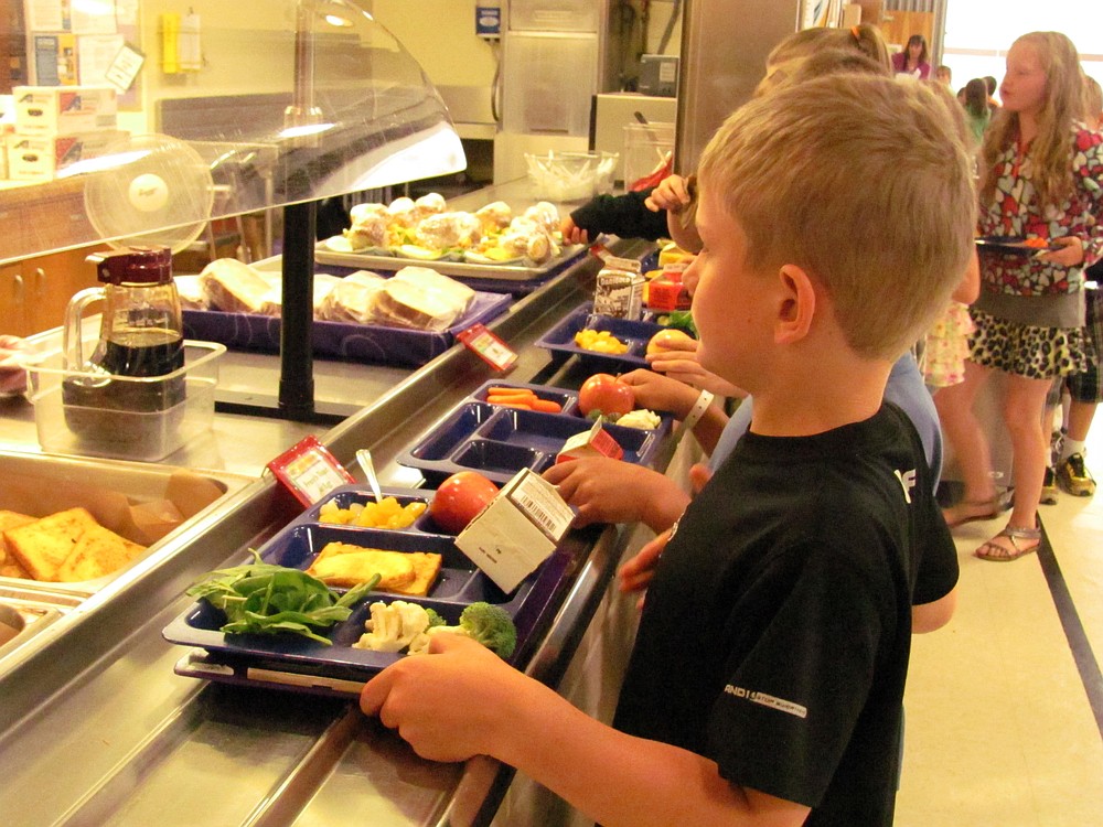Lacamas Elementary School student Jesse Raunig has several servings of fruits and vegetables on his lunch tray. Recent federal regulations require that students take at least one-half cup of these for the lunch to count as a reimbursable meal.