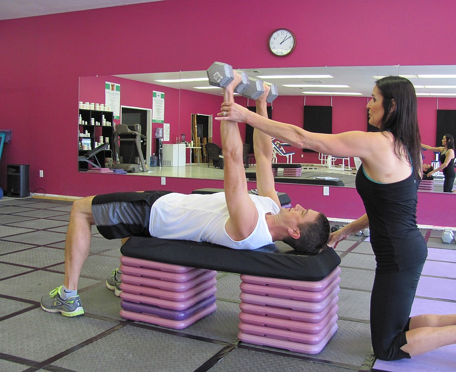 Certified personal trainer Karen Bell works with a client at her Washougal studio. She suggests those who want to lose weight and keep it off commit to a regular exercise and eating plan that they can stick with long term.