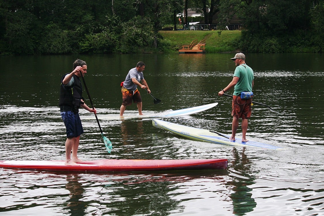 Washougal City Administrator David Scott (left) joined Sweetwood Paddleboard guides Erick Gelbke (right) and Terry Click (center) for a clinic at Lacamas Lake.