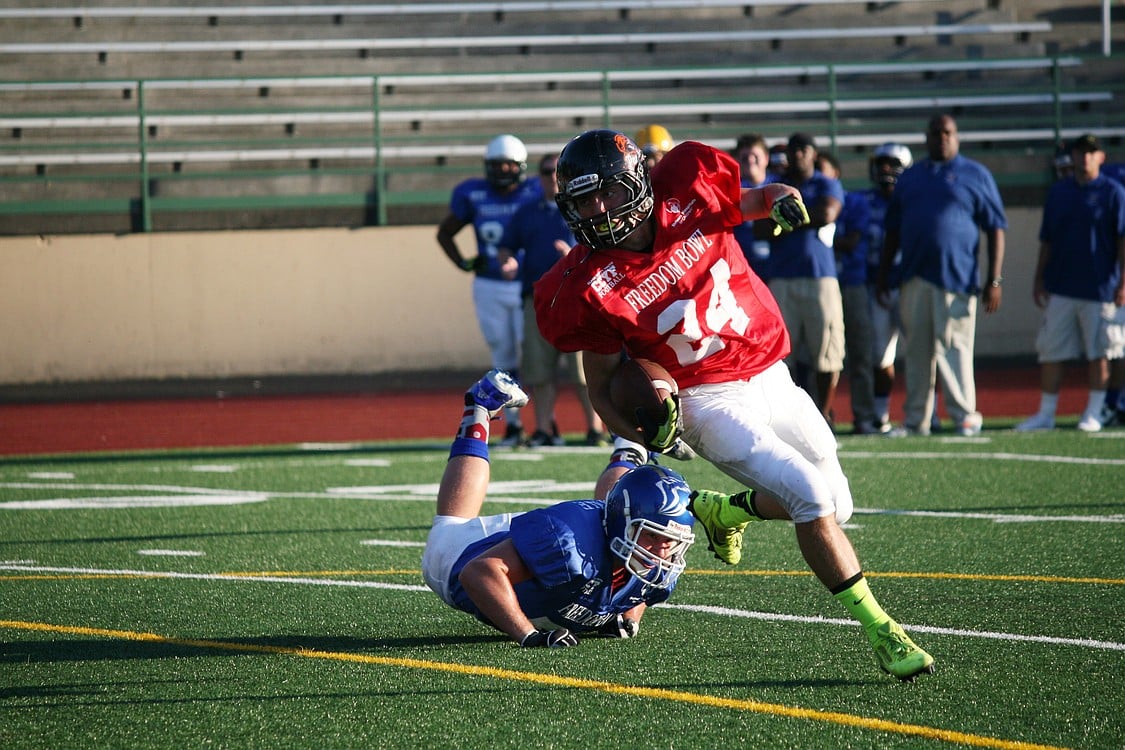 Bobby Jacobs breaks loose from a defender's grasp and scores a touchdown for the American all-stars in the Shriner's Freedom Bowl Classic Saturday, at McKenzie Stadium in Vancouver.