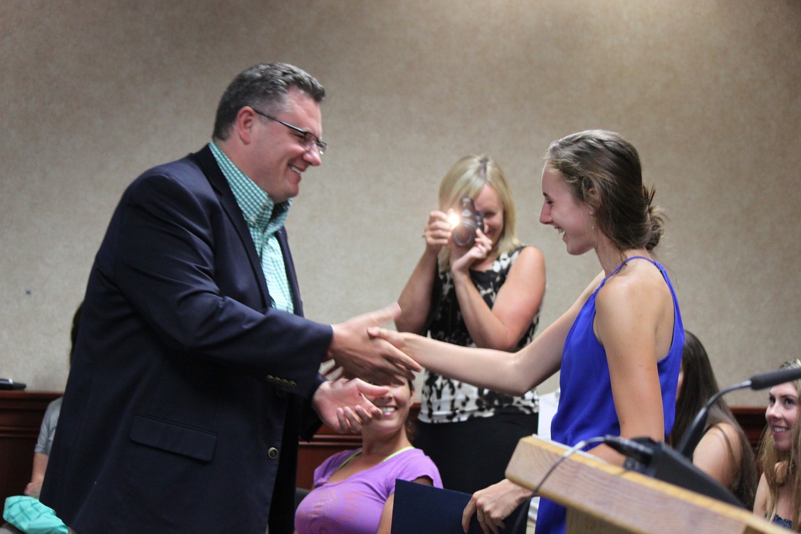 Accomplished distance runner Alexa Efraimson is congratulated by Camas Mayor Scott Higgins on Monday night, following his proclamation that Friday, Aug. 8, would be "Alexa Efraimson Appreciation Day." Efraimson, who will be a senior at Camas High School in the fall, has a long list of state and national track and cross country accolades, including Gatorade National Girls Cross Country Runner of the Year. "If it's OK, I'd love to get my picture with you, so that I can put that on my wall, and maybe someday you could sign it for me," Higgins said to Efraimson.