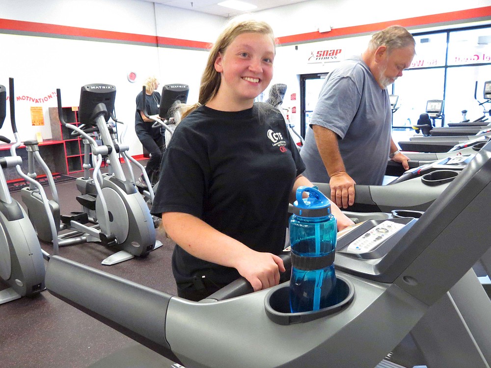 Mary McFarland of Camas (left) and Ron Winders of Washougal (right) build strength and endurance on the treadmills at SNAP Fitness in Camas. McFarland was born with a brain defect and had her hip replaced at the age of 13. Winders, 62, is going in for knee replacement surgery. He hopes for a speedy recovery so he can get back in the gym.