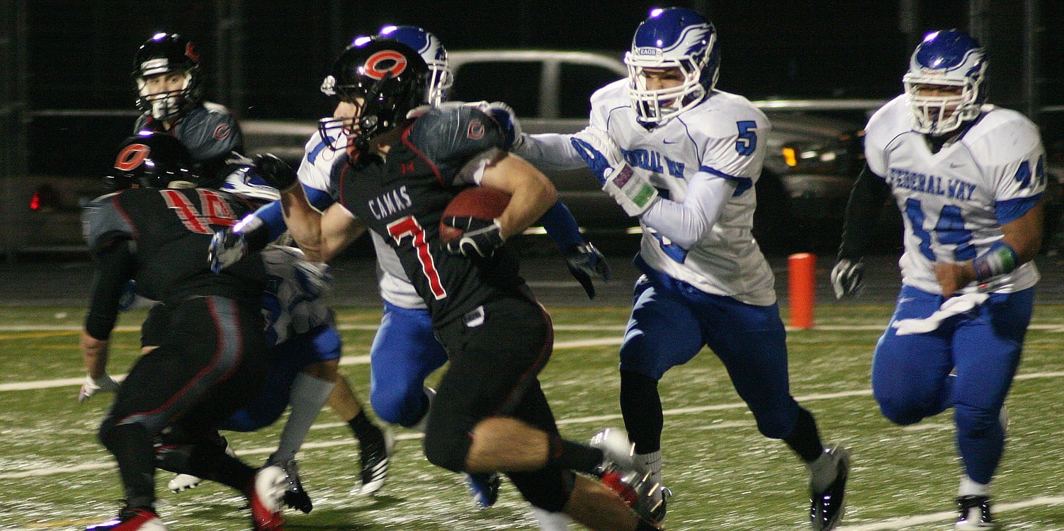 Nate Beasley cuts by three defenders and inches toward his fifth touchdown of the game Saturday, at Doc Harris Stadium. Camas hammered Federal Way 65-32 to earn the opportunity to play in the Tacoma Dome again this weekend.