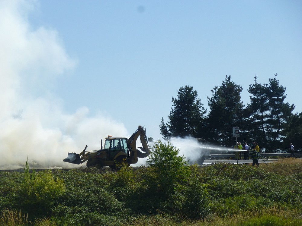 Firefighters work to extinguish a blaze after a truck carrying hay caught on fire Tuesday afternoon at Highway 14 in Washougal.
