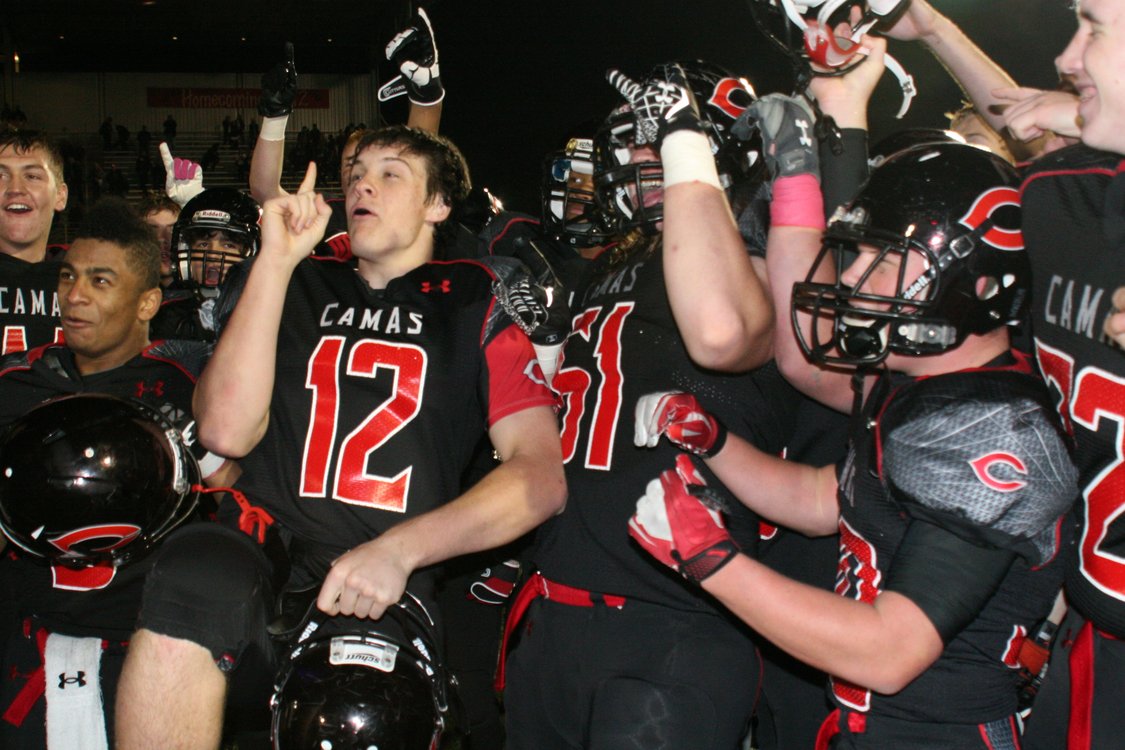 The Camas High School football players celebrate after going undefeated in their first year in the 4A Greater St. Helens League.