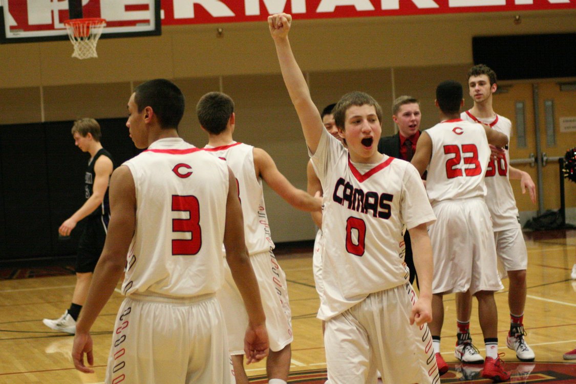 The Camas High School boys basketball players celebrate after beating Skyview 50-48 Friday, in Camas.