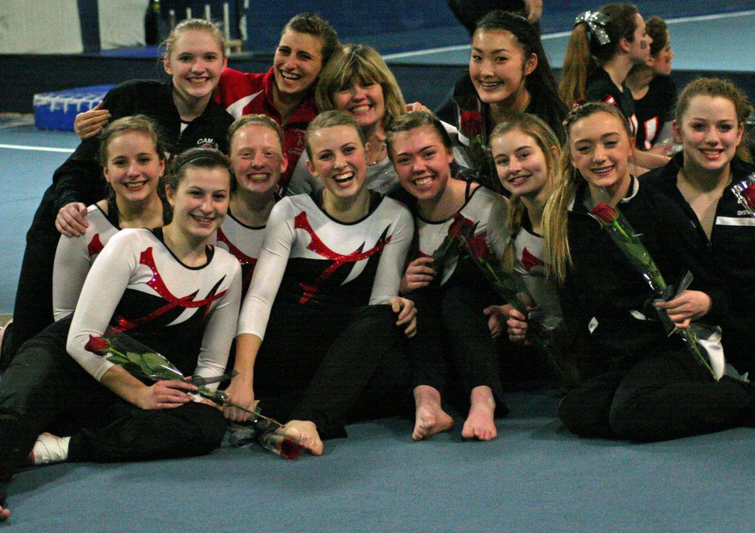 The Camas High School gymnasts and coaches are all smiles after becoming district champions Wednesday, at Northpointe in Vancouver.