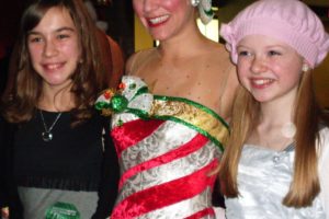 Liberty Middle School students Ellie Cook (right) and Kelsie Ackerman pose with one of the Rockettes at a meet-and-greet on Christmas Eve.