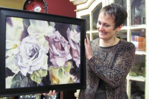 Carrie Schulstad admires one of the pieces of artwork that's been submitted for Camas First Friday Arts and Letters. The event features an art contest for middle and high school students, as well as readings by local authors.