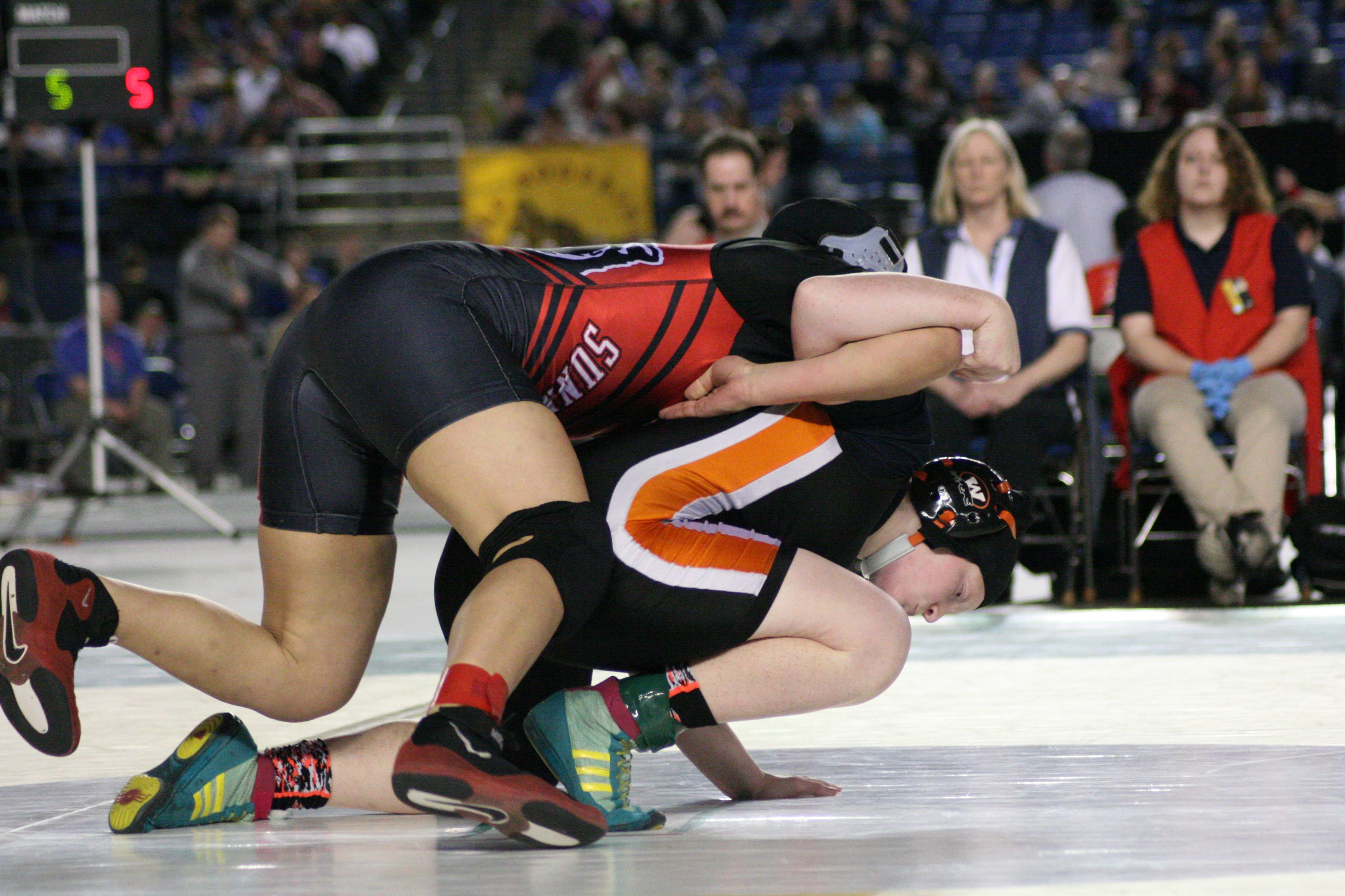 Abby Lees throws Jessica Cardenes over her shoulder in the 155-pound state championship match Saturday, at the Tacoma Dome