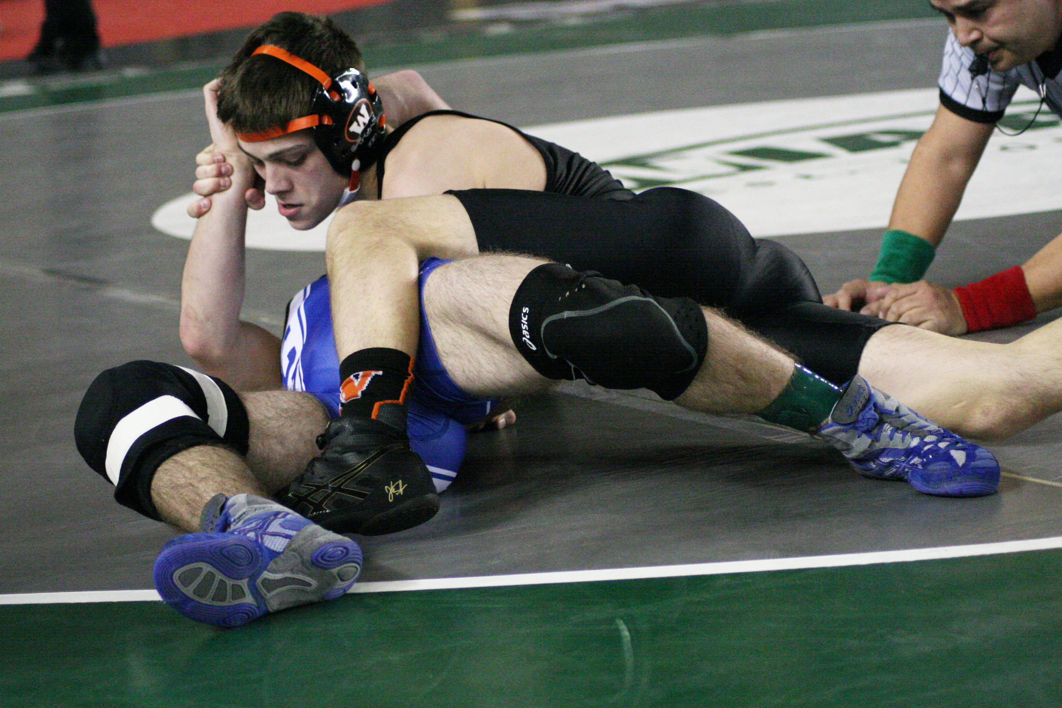 Zach Oster sticks Adam Adkinson to the mat during the 2A 120-pound state semifinals. This move gave the Washougal High School senior the confidence to beat Adkinson in overtime.