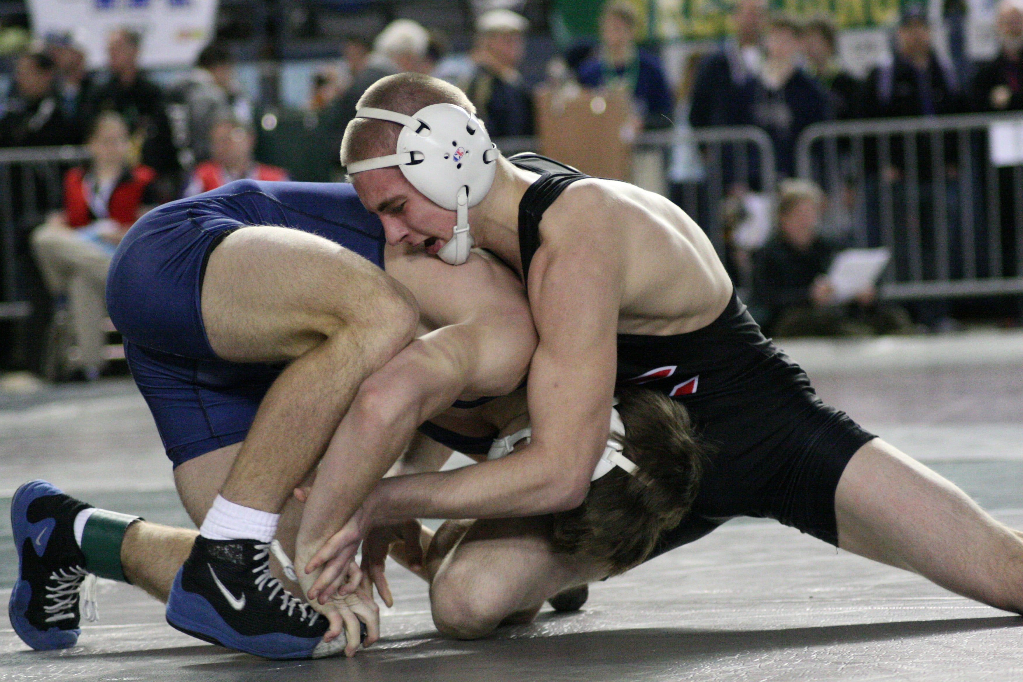 Bryant Elliott (right) earned fifth place for the Papermakers in the 4A 132-pound state championship bracket, at the Tacoma Dome.