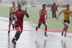 Sheets of rain did little to slow down Julian Samuels (left) and the Camas High School track and teams Thursday, at Cardon Field. Samuels snatched first in the 100-meter dash (pictured abvoe), anchored the 400 relay team to victory and placed second in the 200. The Papermaker boys beat Kelso 87-58.