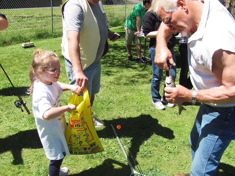 Catching a fish brings a smile to a kid's face during the 2011 Camas Moose Lodge fishing derby.