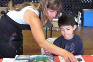 Local artist Elida Field helps third-grader Tony Kajino put the finishing touches on his painting.  She recently moved her business from her home studio in Washougal, to Northeast Cedar Street  in Camas, where Workshed Interactive was located. That business has moved into a smaller space. Field plans on using the space for a "working gallery," where the community will be able to take classes and have parties.