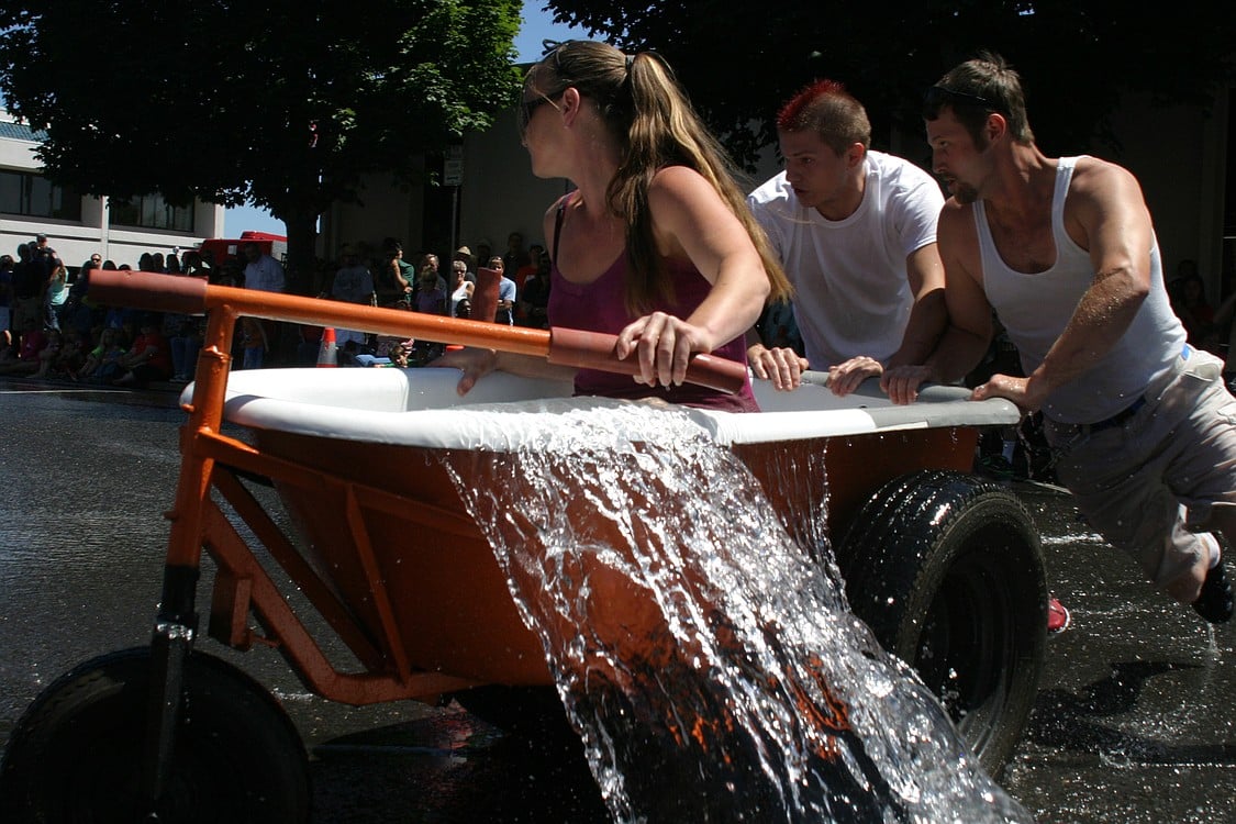Tanya Groth steers, and Robert Melton and Greg Irwin push, the Bathtub Bandits to victory at the Camas Days Bathtub Races Saturday. The trio won this event for the fourth year in a row.
