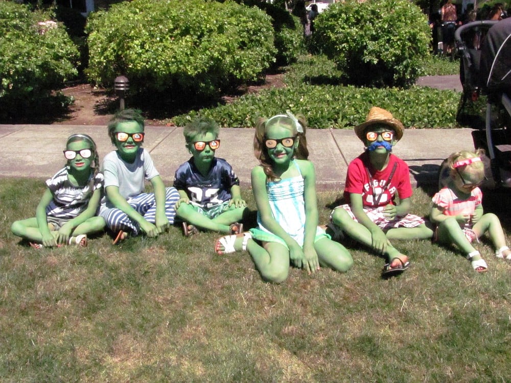 These kids got into the spirit of things by wearing sunglasses with eyeballs on them and green body paint for the Kids Parade on Friday.