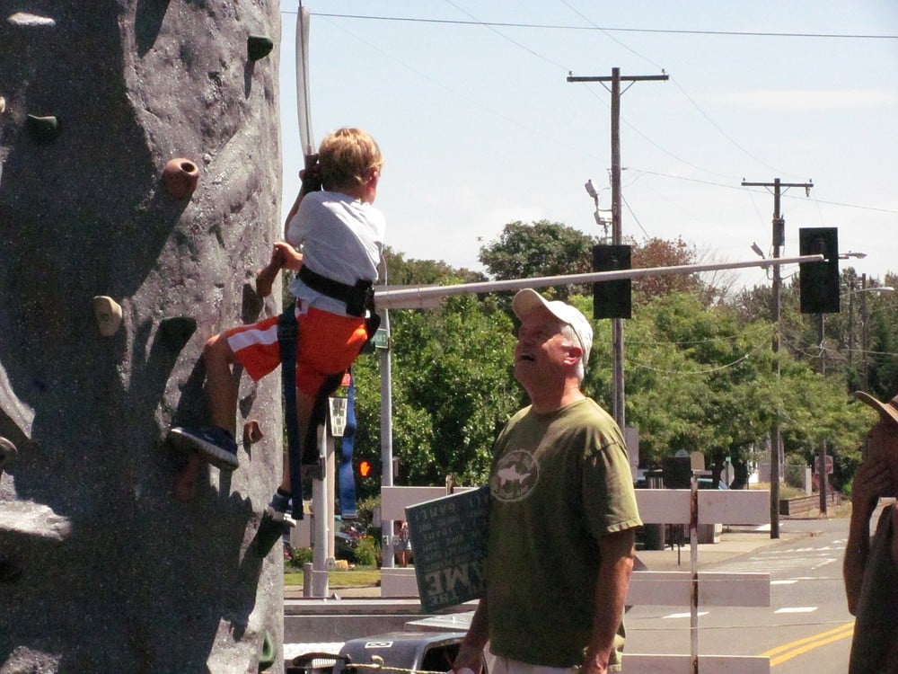 A youngster climbs the rock wall at Camas Days Kids Street.