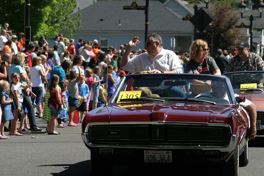 Camas Mayor Scott Higgins and his wife, Allison, toss candy to the crowd during the Grand Parade.