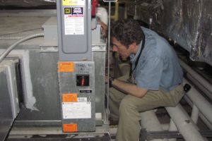 Geert Aerts checks the HVAC equipment at Washougal High School. He is helping the school district with an energy conservation project that includes retro-commissioning the heating and cooling systems.