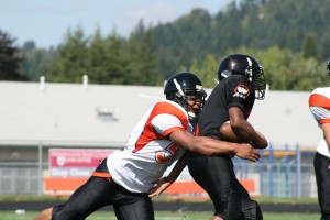 D'Andre Aaron (left) delivers a hit on defense for the Washougal High School football team during practice.