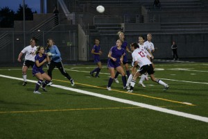 Carley Marshall (13) heads the ball into the net off a corner kick, while Jane Benson, Kailee Esser and Annike Sumpter (left to right) look on. The Camas High School girls soccer team topped defending state champion Columbia River 2-0 Thursday, at Doc Harris Stadium.