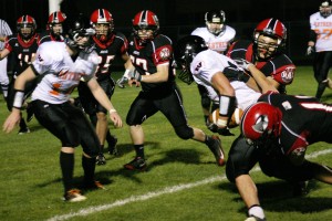 Sam O'Hara (right) plows through two defenders to get to the end zone for Washougal Friday, in Longview.
