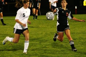 Tasha Reeves of Washougal (right) and a Hockinson Hawk (left) set their sights on a soccer ball Oct. 5, at Hockinson High School. The Hawks defeated the Panthers 3-1.