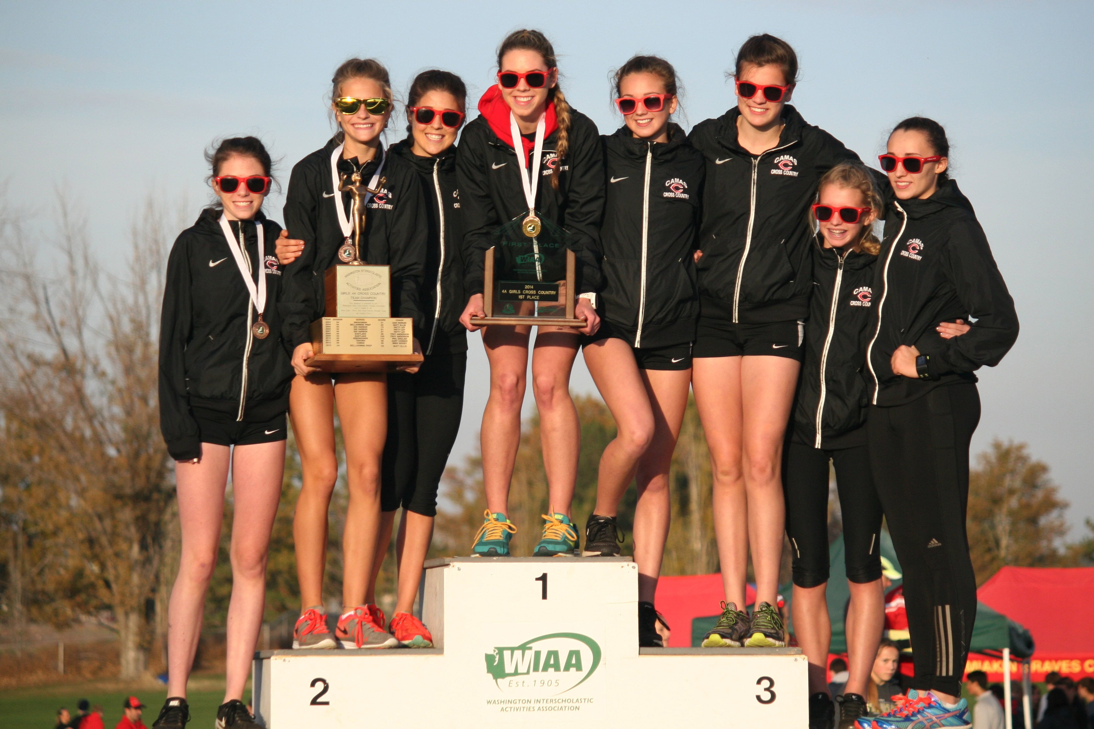 The Camas High School girls cross country team stands on the podium as state champions Saturday, at the Sun Willows Golf Course, in Pasco. Left to right: Emma Jenkins, Emily Wilson, Maddie Woodson, Alissa Pudlitzke, Kaylee Merritt, Gabrielle Postma, Brooke Roy and Alexa Jones.