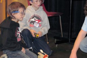 Helen Baller Elementary School third-graders Martin Knysh (left) and Sammy Burnett (right) have the launch distance of their gummy bear measured on Saturday during the Elementary Science Olympiad at Clark College.  The "Gummy Bear Long Jump" was one of five competitive events held during the educational event, which was attended by nearly 300 students from schools around Clark County.