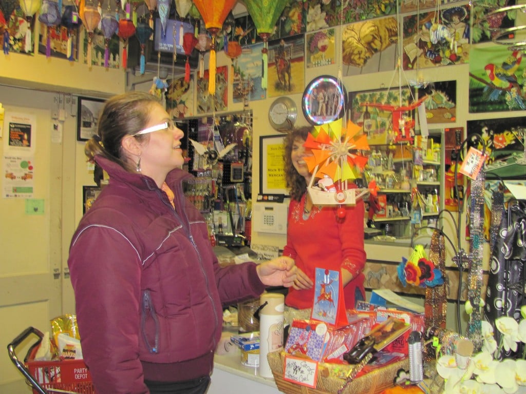 Tessa Condon of New Orleans inspects a mobile at Main Street Merchantile in Washougal while owner Heidi Kramer looks on. "It's great because you never know what you'll find or what you need," she said.