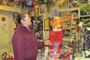 Tessa Condon of New Orleans inspects a mobile at Main Street Merchantile in Washougal while owner Heidi Kramer looks on. "It's great because you never know what you'll find or what you need," she said.