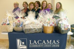 Lacamas Community Credit Union employees (left to right) Linda Bolton, Marsha Leifsen, Eve Rossmiller, Sherri Smith, President/CEO Kathleen Romane, Sarah Giddens and Hillery Losli are pictured behind several of the gift baskets that were assembled for local families in need. This is the third year that the credit union sponsors the holiday dinner basket program.