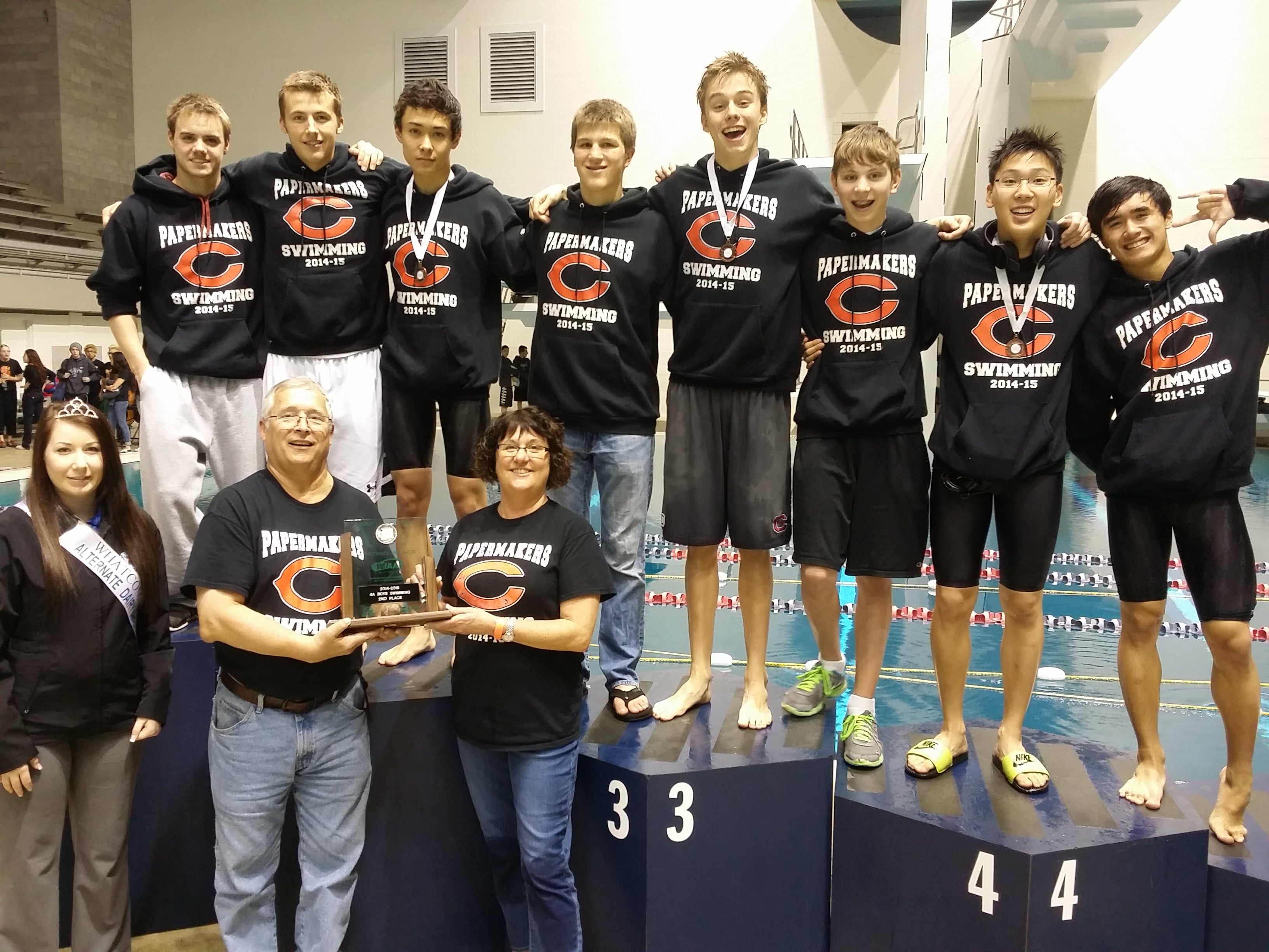 The Camas High School boys swimming team clinched second place at the state championship meet Saturday. Pictured on the podium (left to right): Luke Albert, Lucas Ulmer, Tom Utas, Jeff Fadlovich, Kasey Calwell, Finn McClone, Mark Kim and John Utas. Coaches Mike Bemis and Leslie Dahlen are holding the trophy.
