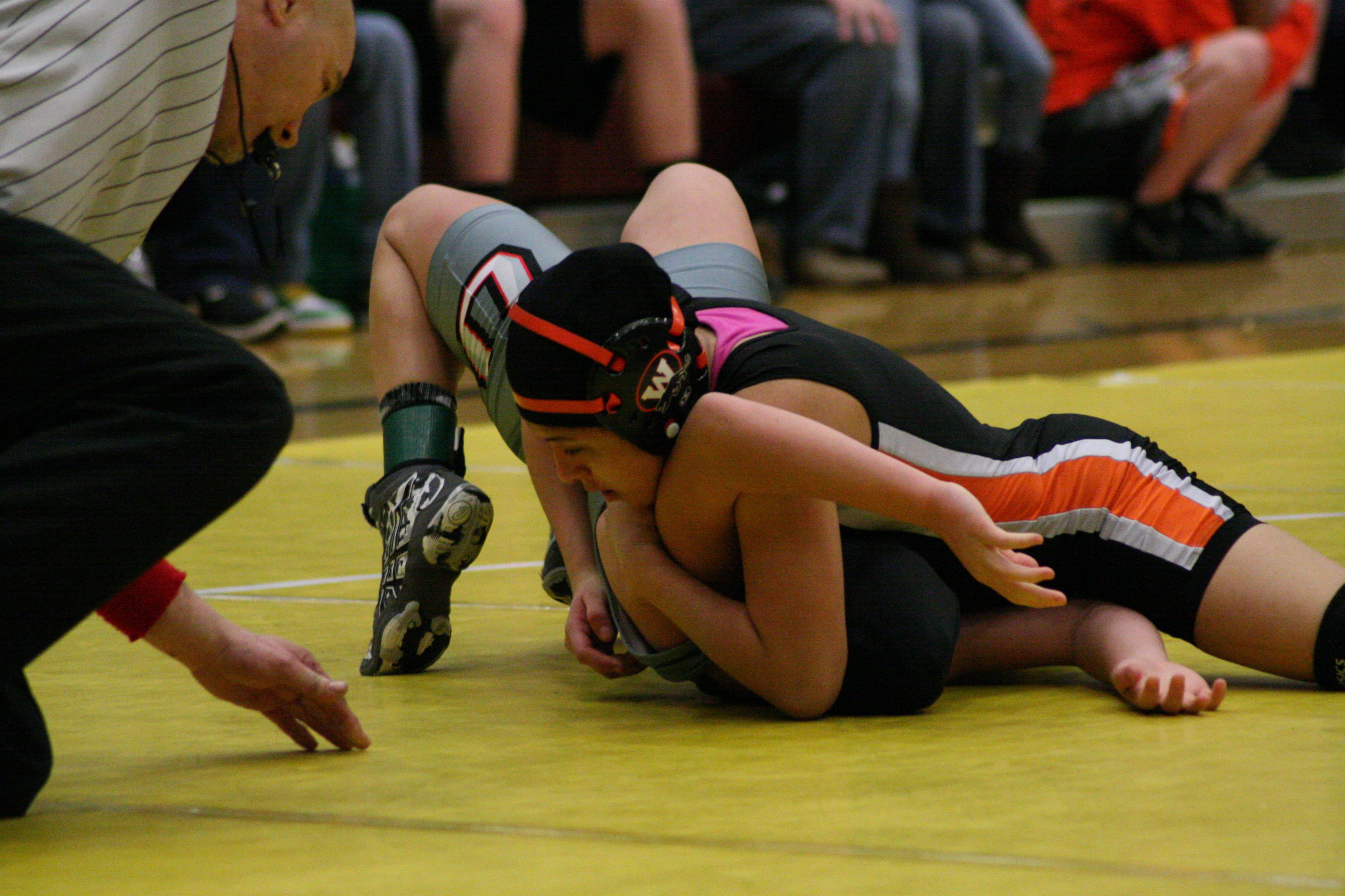 Yaneli Martinez grounds her opponent in the 105-pound county championship match.