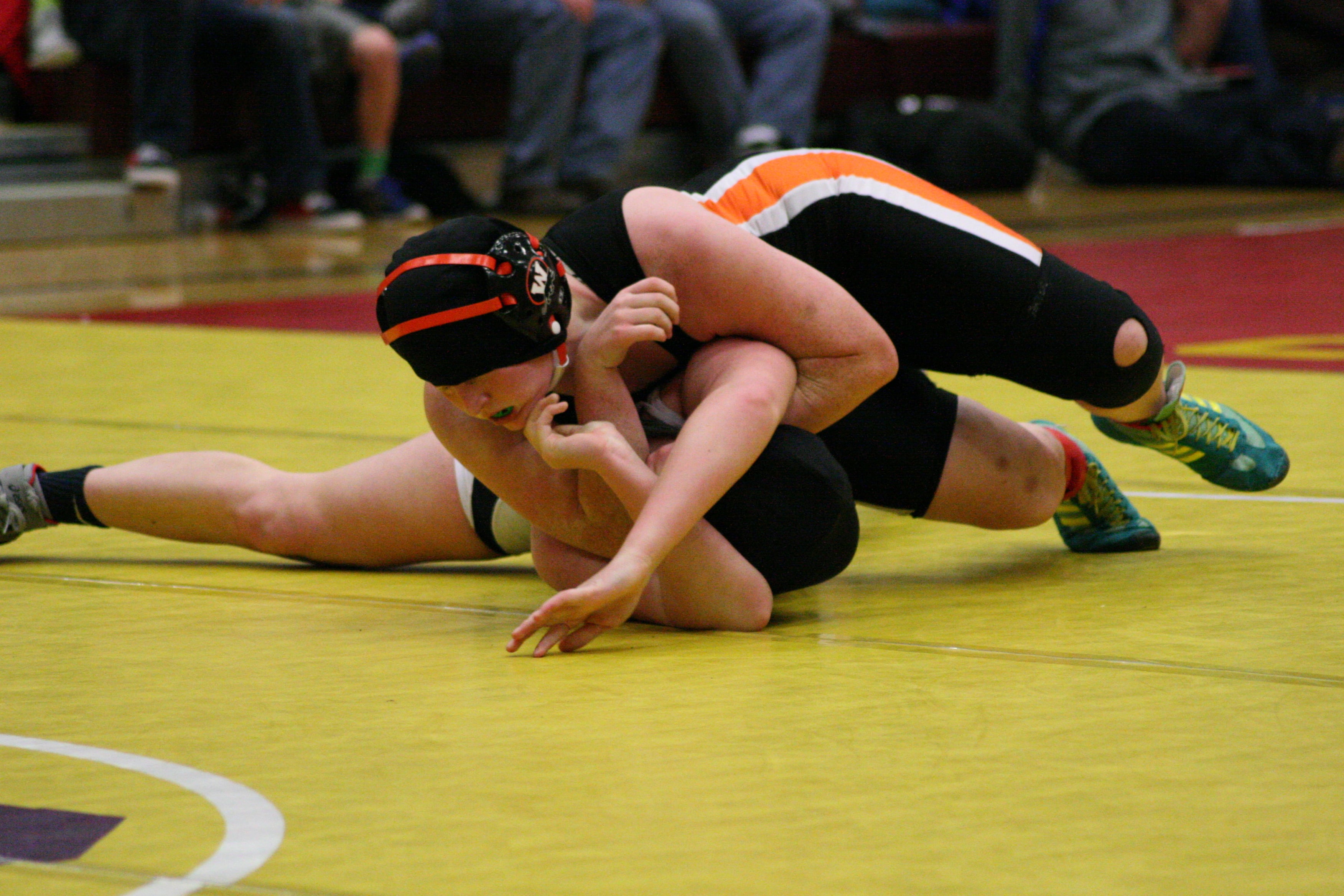 Abby Lees twists her opponent during the 155-pound title match.