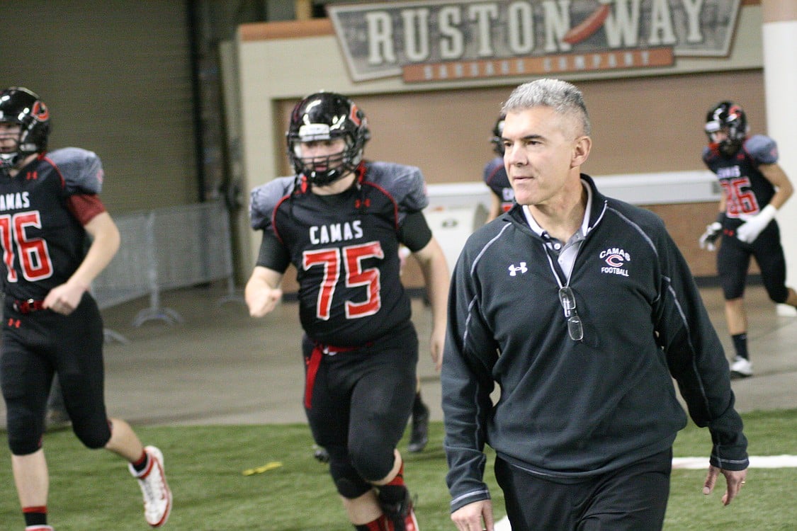 Head coach Jon Eagle leads an excited work force on to the football field.