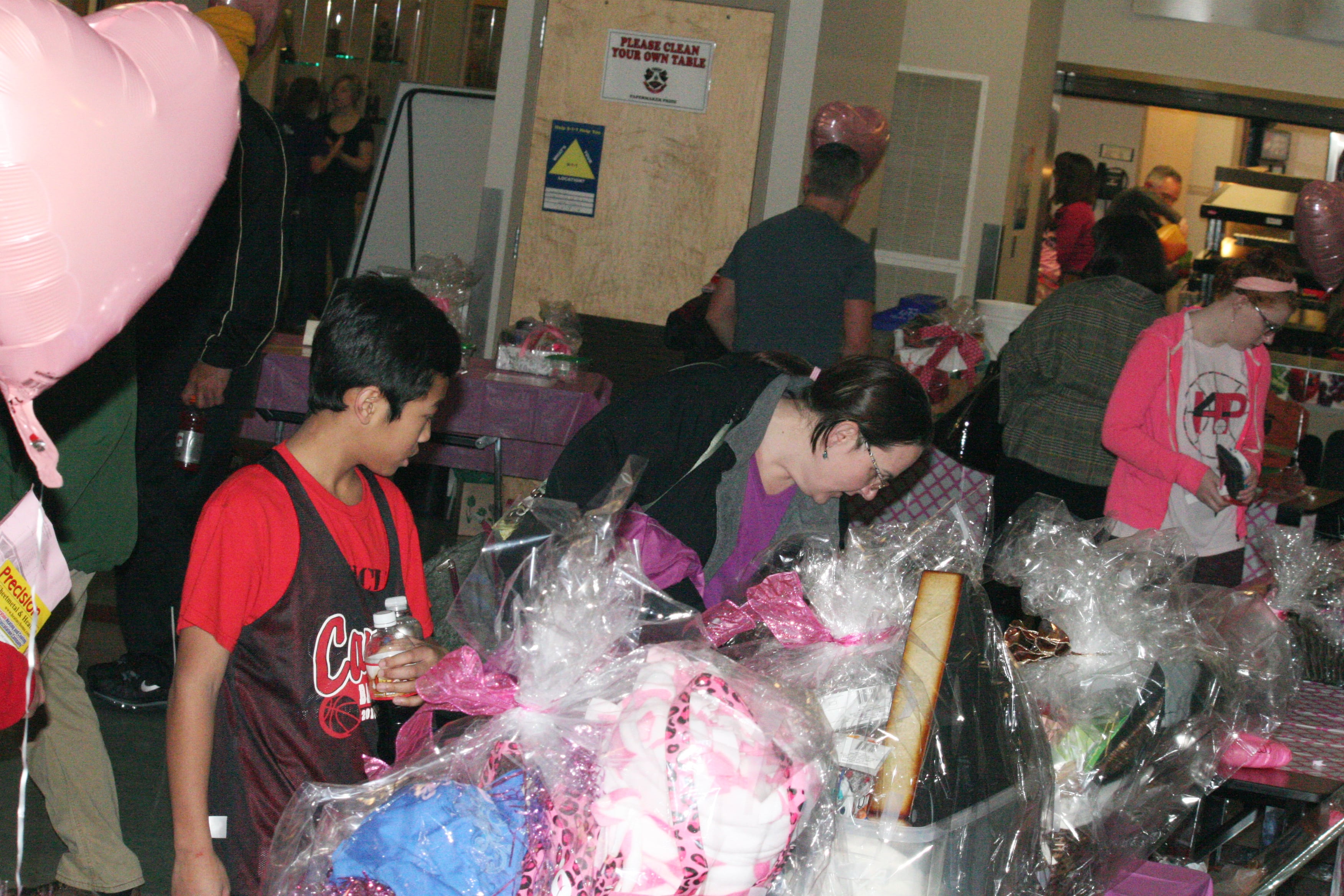 Fans enter a raffle to try and win a Hoops For Pink basket.