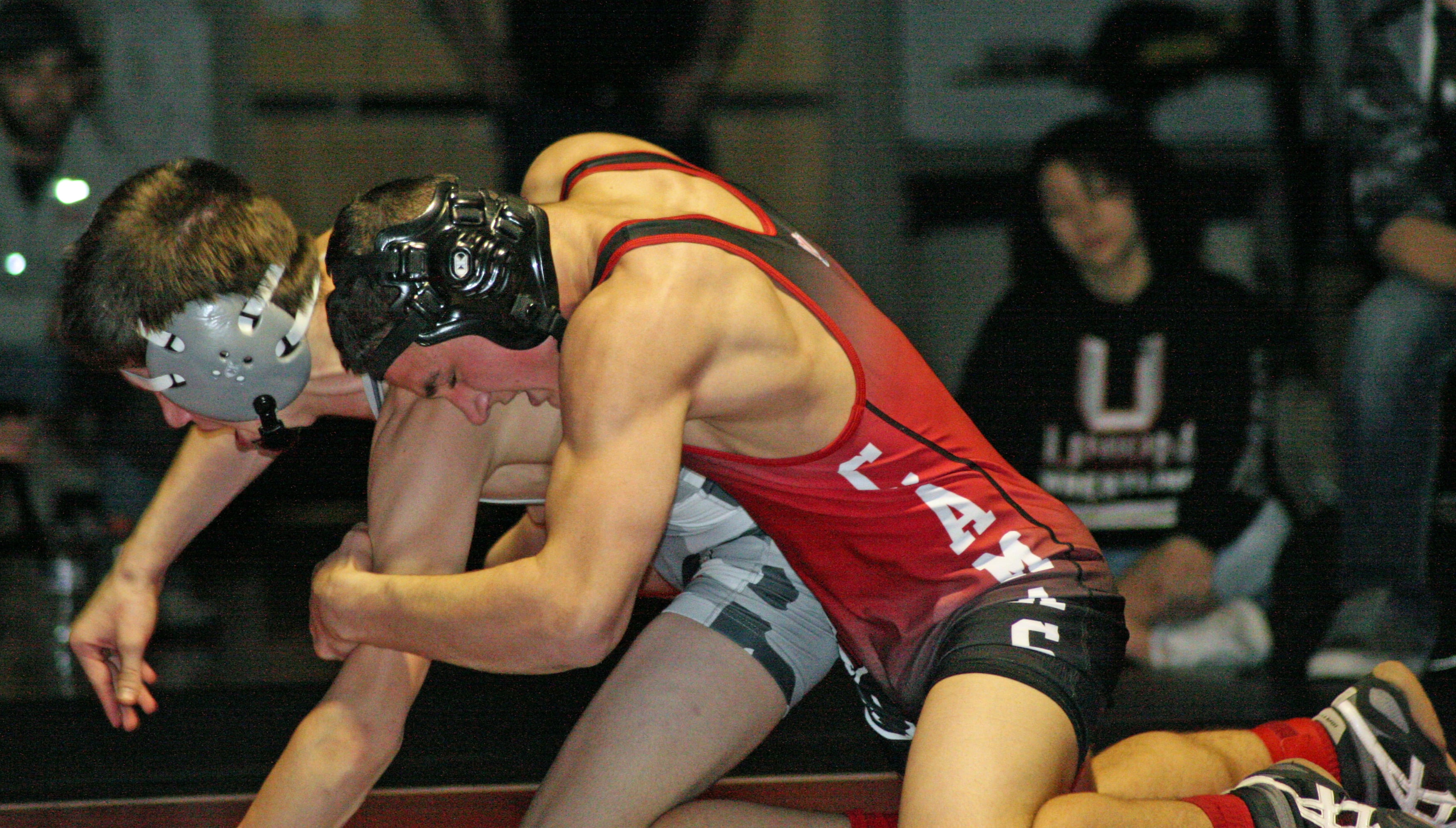 Rylan Thompson drags his rival from Union down to the mat for an early 2-0 advantage in the 126-pound 4A district championship match.