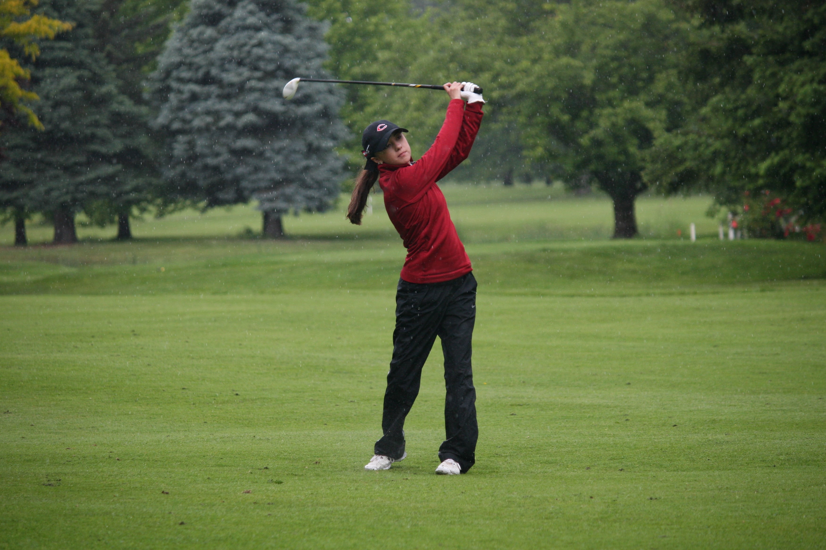Maddie Miller plays on through the rain Wednesday, at Green Meadows.