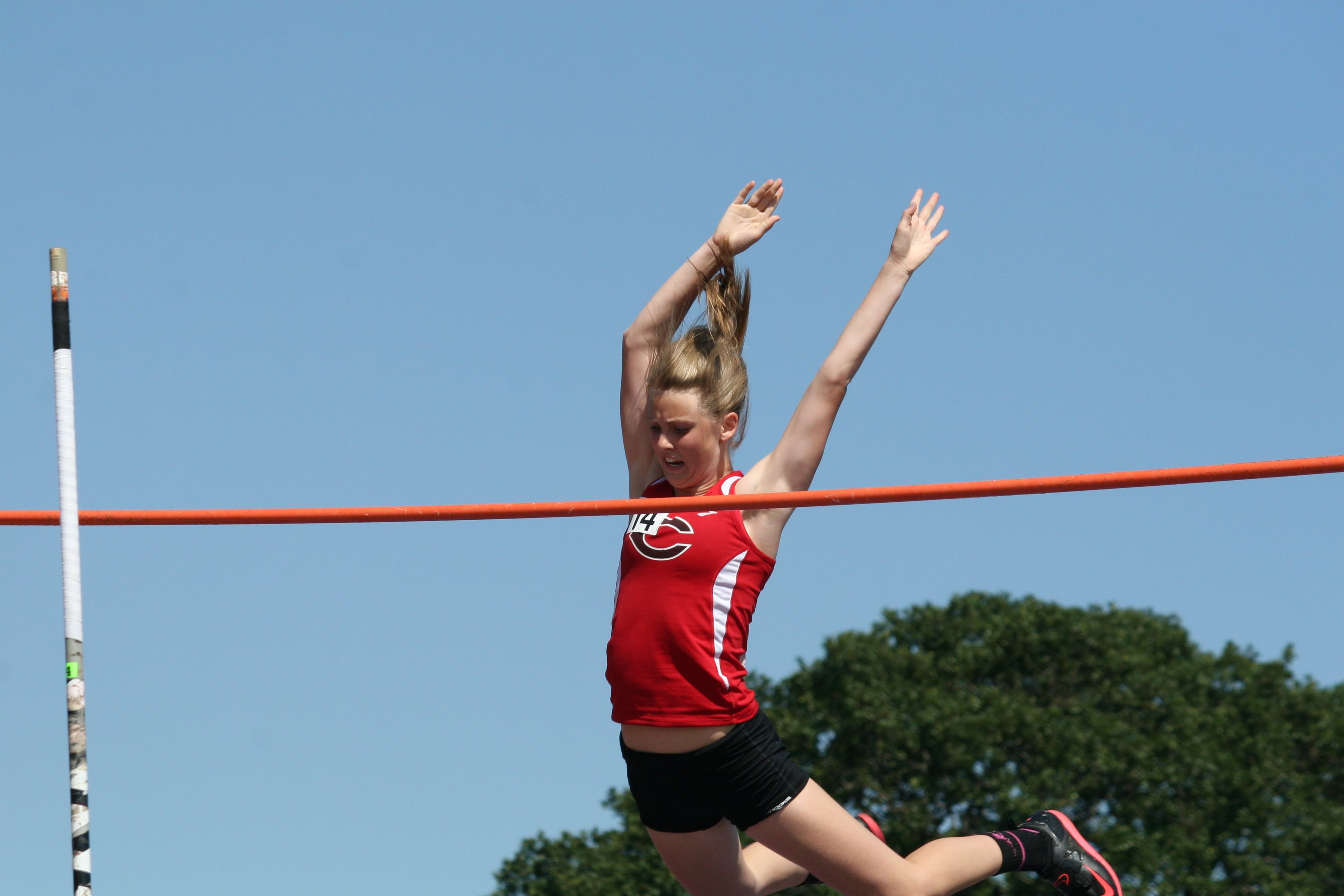 Caleigh Lofstead sails over the bar for the Papermakers.